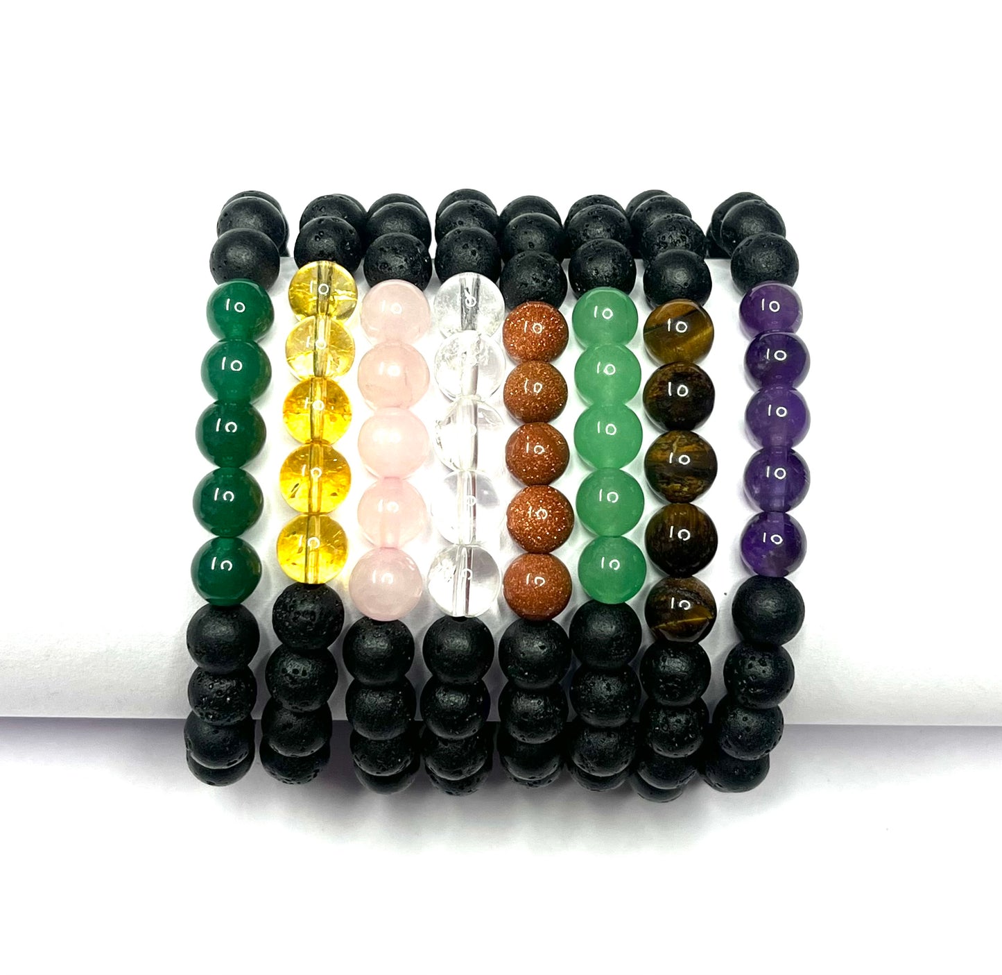 Set of beaded bracelets in various colors on a white background