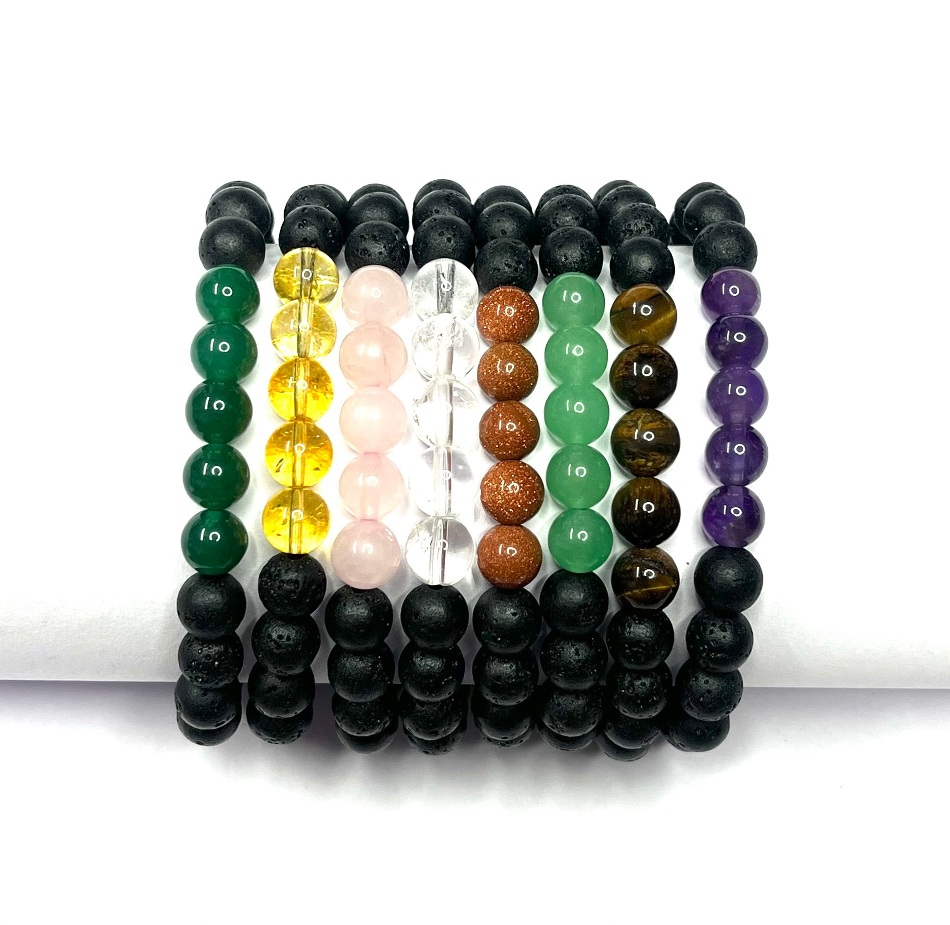 Set of beaded bracelets in various colors on a white background