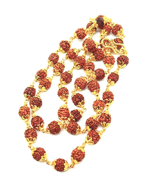 Necklace with red beads and gold chain on a white background