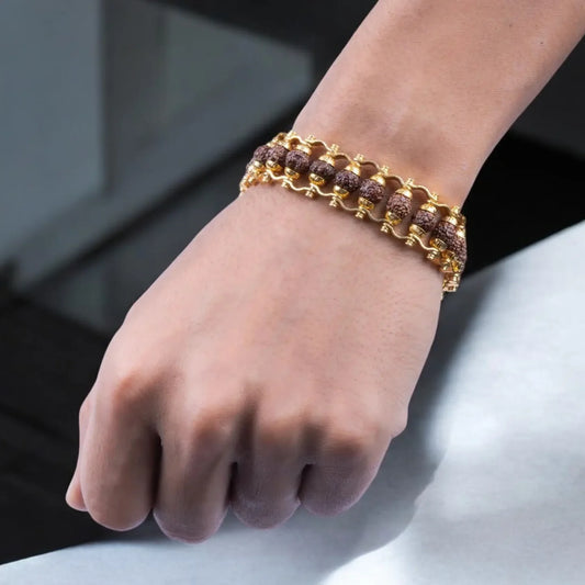 Gold bracelet on a wrist with a blurred background