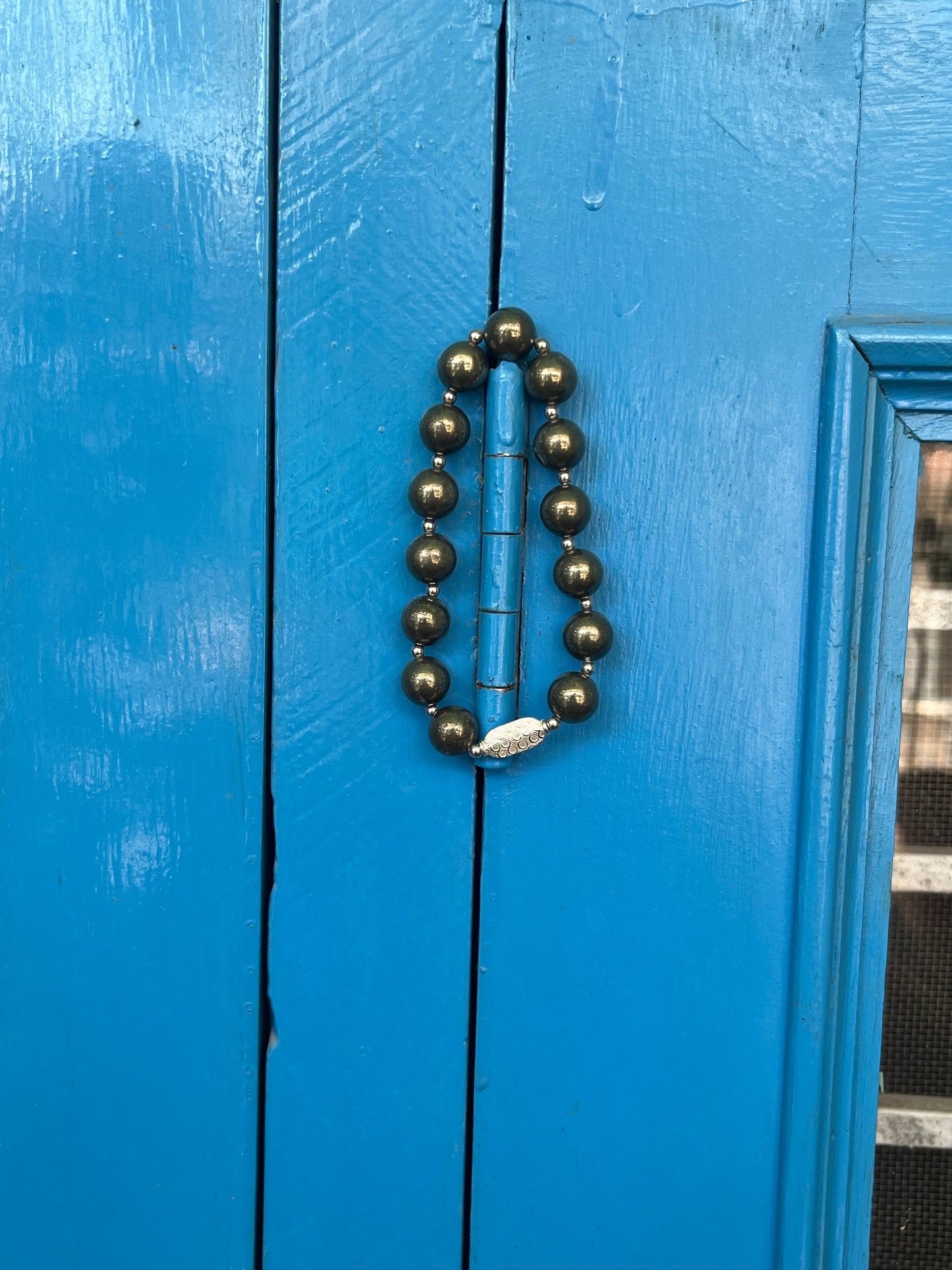 Person wearing premium pyrite healing crystal bracelet on wrist 925 silver money magnet for abundance