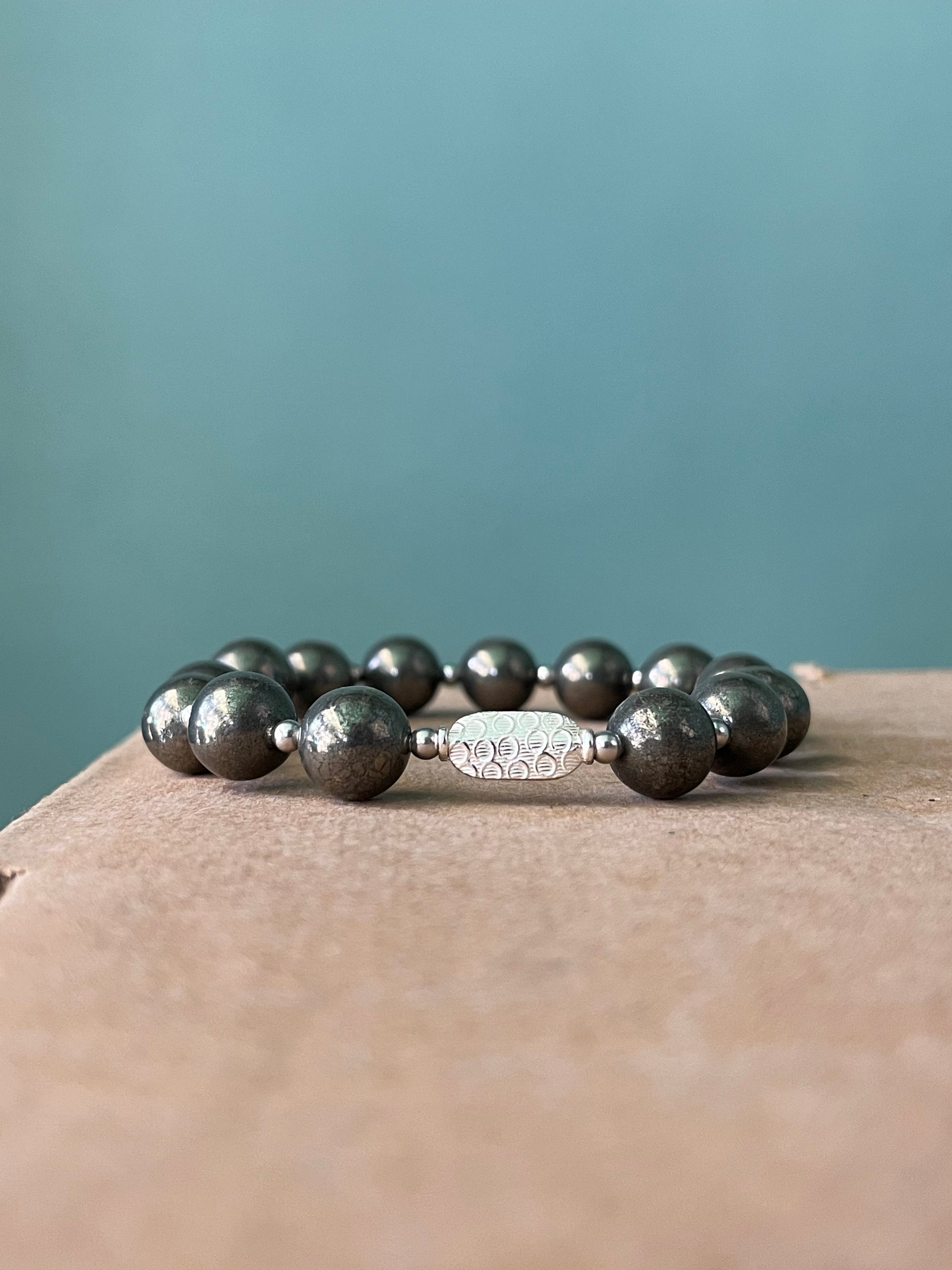 Close up view of 10mm pyrite beads with 925 sterling silver in money magnet bracelet showing premium quality