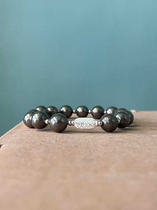 Close up view of 10mm pyrite beads with 925 sterling silver in money magnet bracelet showing premium quality