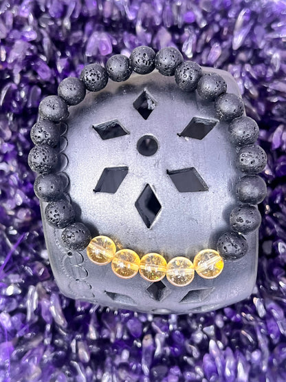 Decorative stone with black and yellow beads on a purple crystal background